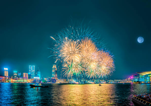 istock Fireworks display at Victoria Harbor in Hong Kong on a moonlit night. 2047720920