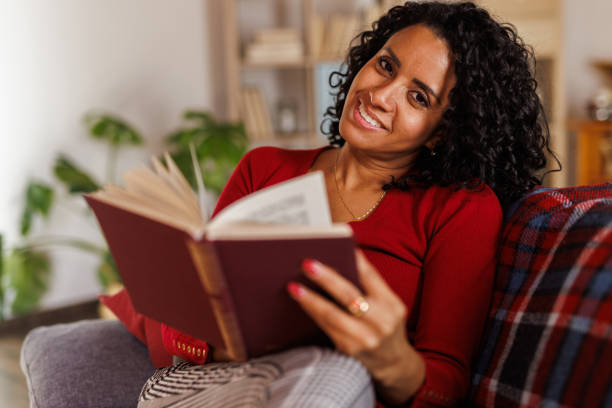 istock Simply relaxing on the sofa and reading a good book during Christmas 2047723554