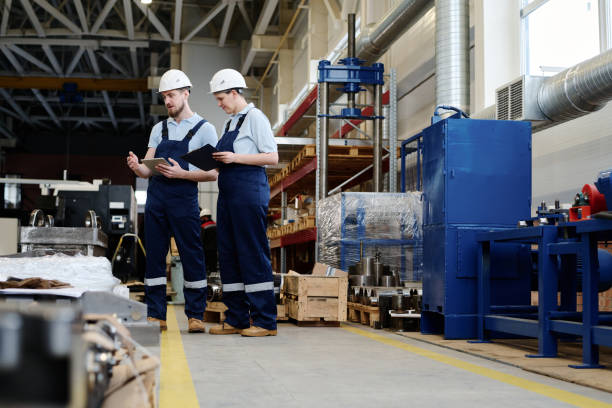 istock Two People Working In Modern Factory 2047728369