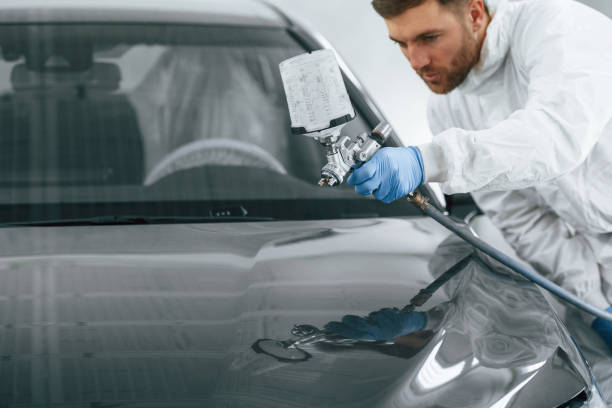istock Man is painting a car by using spray guy 2047736360