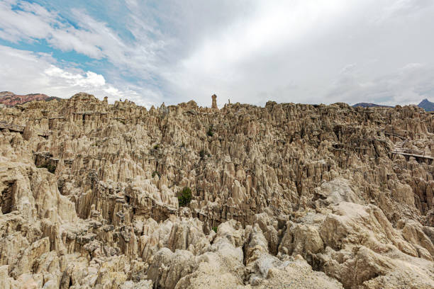 It showcases an otherworldly landscape reminiscent of the moon's surface. Situated near La Paz, it features surreal rock formations, deep canyons, and rugged terrain sculpted by wind and water erosion over millions of years. Visitors can explore its unique beauty, with sunset vistas casting a mesmerizing glow over the lunar-like landscape.