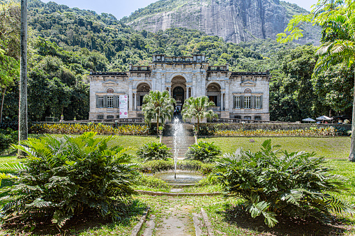 Rio de Janeiro, Brazil - December 27, 2019: Nestled at the foot of Corcovado Mountain in Rio de Janeiro, it is a historic public park known for its lush greenery and scenic beauty. Originally a private residence, it now houses an art school and hosts cultural events. Visitors can explore the gardens, admire the mansion's architecture, and enjoy views of the surrounding mountains.