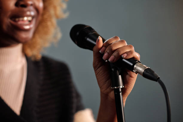 istock Hand of young comedian with microphone 2047765225