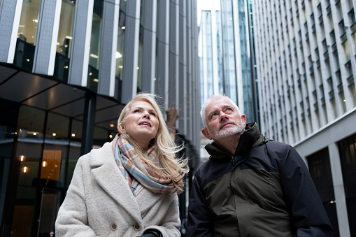 Senior couple in the city looking up at the skyscrapers
