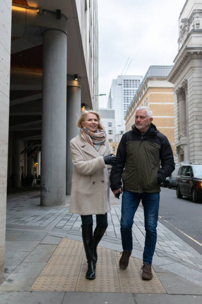 istock Senior couple walking down city street 2047772043