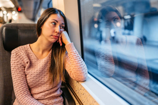 istock Sad Young Woman Looking Out The Window On The Train 2047793687