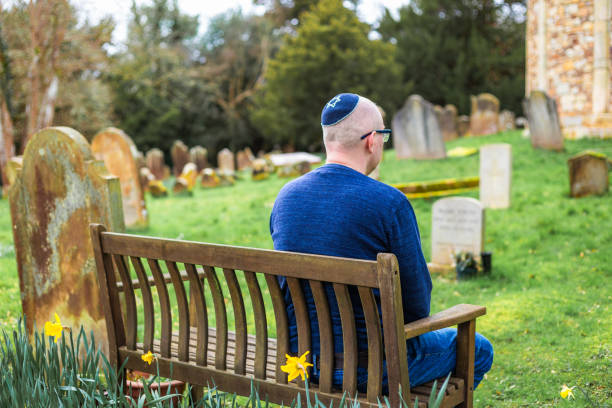 istock Jewish man sitting on bench outside synagogue 2047811965