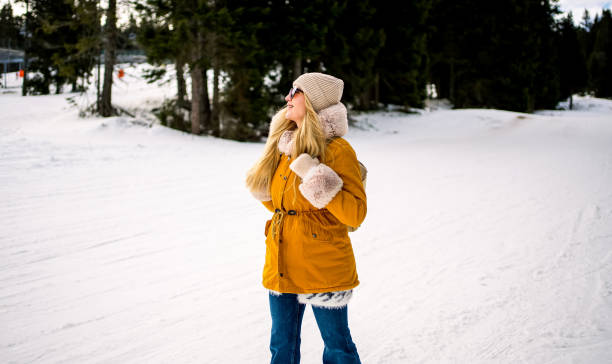 istock Woman walking in the snow covered mountain 2047825326