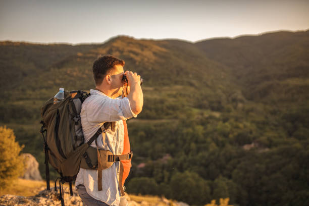 istock Men with backpack birdwatching at the top of the mountain 2047833072