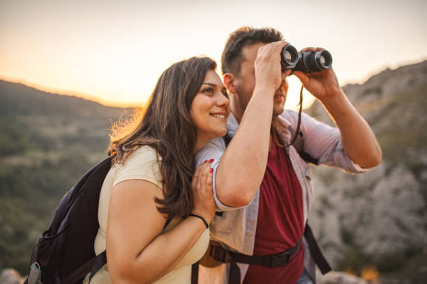 istock Men with backpack birdwatching at the top of the mountain 2047833073