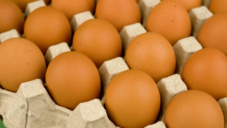 Orange chicken eggs in the egg stall rotate slowly, egg shells, high protein food