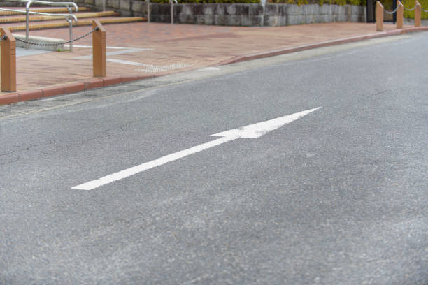 An arrow drawn on the ground in a parking lot indicating the direction of exit