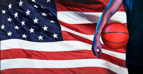Sports, usa flag, and basketball with hand of man for fitness, training and competition match. Championship, games and muscle with athlete and ball with American pride for national, league and club