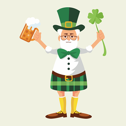 A man in traditional Irish costume celebrates St. Patrick's Day with a beer and clover in his hands. On white and transparent background.