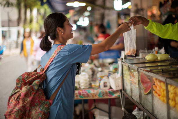 Woman healthcare worker buying lunch at the street market.