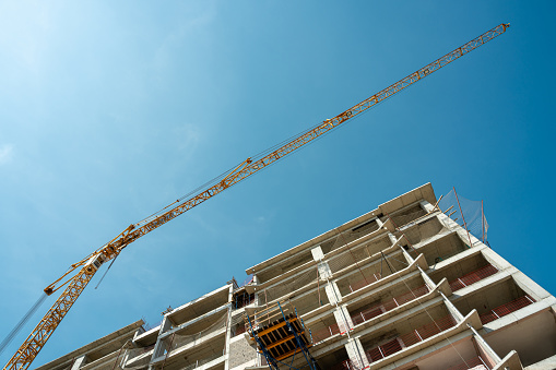 Construction crane working on large construction site