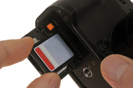 Putting a memory card into a camera close-up