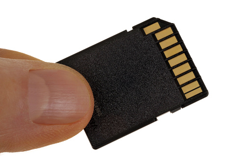 Memory card in hand close-up on white background