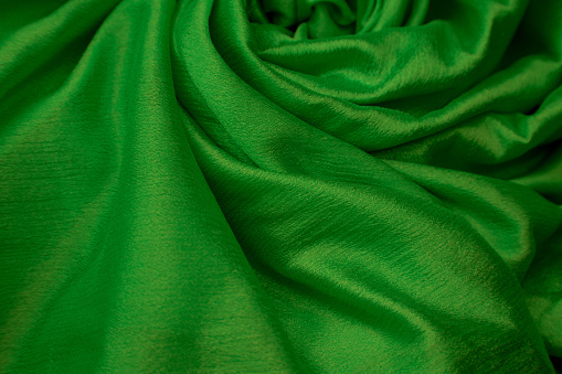 The green fabric draped on the backrest
