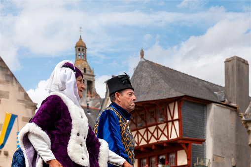Saint Renan, France - July 16 2023: Couple dancing in medieval attire on a platform located on the old market square during the Saint Renan Medieval Festival.