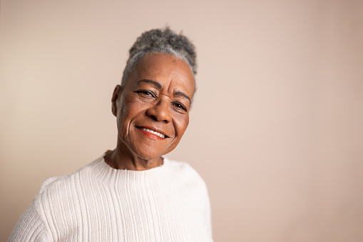 Portrait of a senior woman on a beige background