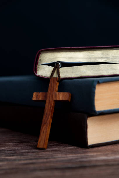 istock Bible and religious cross on wooden table 2047953495