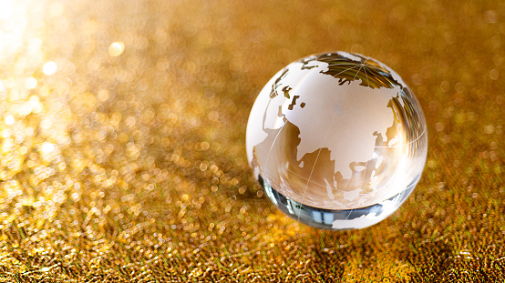 Glass globe on golden background