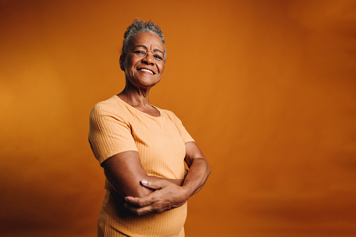 Portrait of a senior woman on a orange background