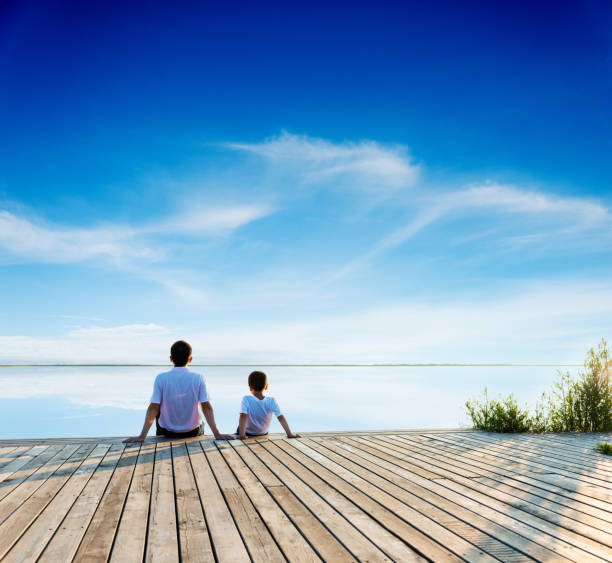 Father with son sitting on the deck
