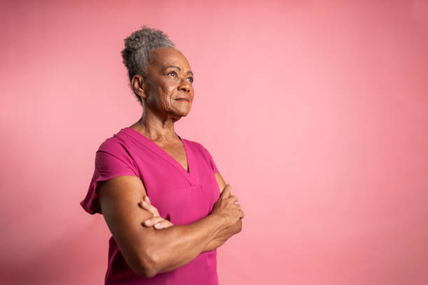 istock Senior woman contemplating on a pink background 2047962439