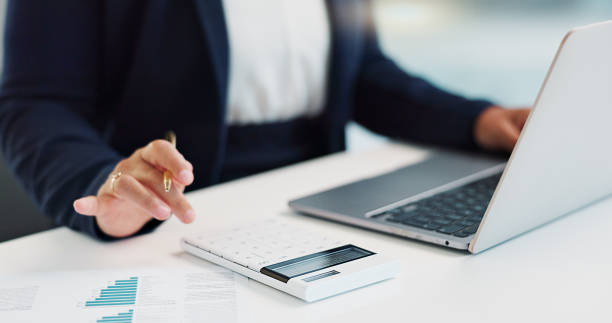 istock Business hands, calculator and finance on computer for budget planning, data analysis or statistics report in office. Bookkeeping accountant or person with documents, numbers and typing on a laptop 2047978252