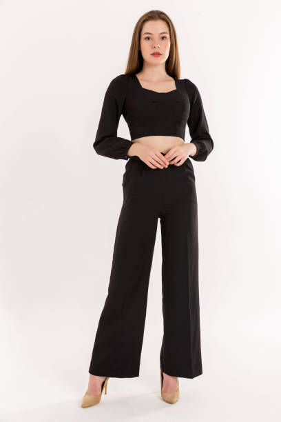 istock Brunette young woman wearing black blouse and black trausers. 2047981507