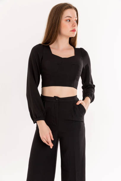 istock Brunette young woman wearing black blouse and black trausers. 2047982548
