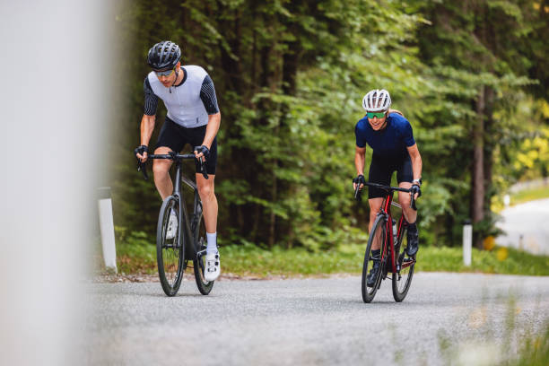 istock Recreational Cyclists Riding Bicycles Uphill On An Empty Road 2047984117