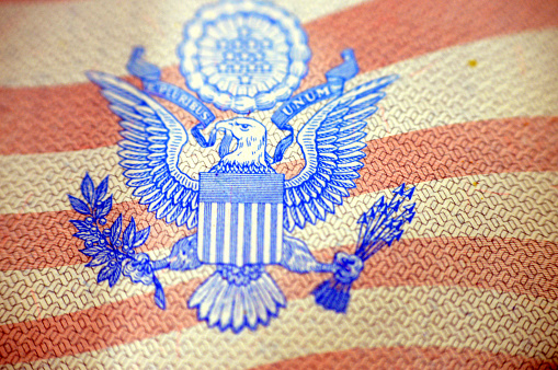 A close up of the United States of American passport, passports are issued to the American citizens and nationals, Travel, tourism concept, American visa and traveling to other countries, selective focus