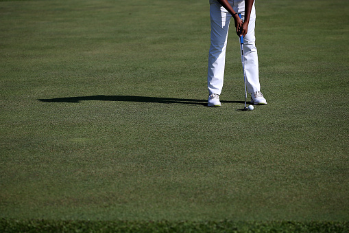 Focus on golfer playing golf