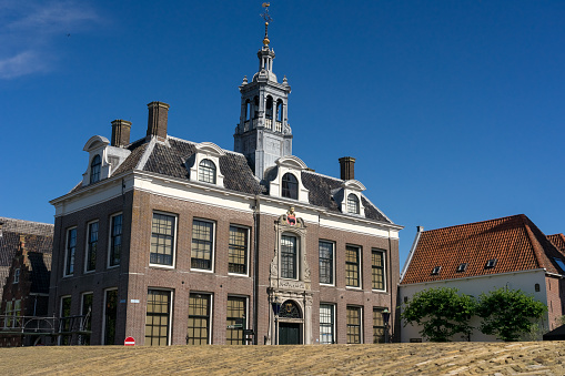 Edam, Netherlands - July 10, 2023: Edam museum in the Dam square of the beautiful city of Edam, Netherlands, with its typical houses in a sunny day.
