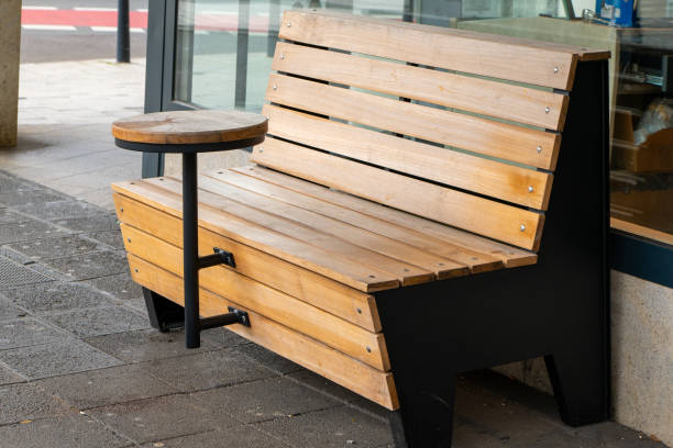 istock a wooden bench with a small table in a town 2048022916