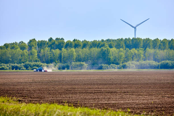 A tractor works the Agriculture Field on a summer day