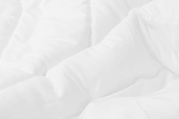 close up top view of white bedding sheet and wrinkle messy blanket in bedroom after wake up in the morning. - selimut seprai foto potret stok, foto, & gambar bebas royalti