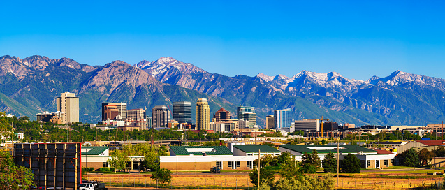 Skyline of Salt Lake City downtown in Utah with Wasatch Range Mountains in the background.