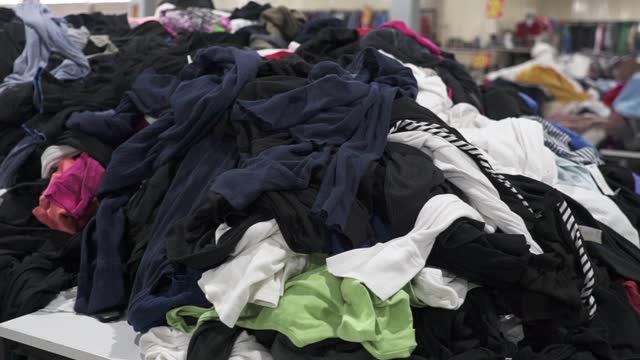 Used clothes. A big pile of old unnecessary clothes. Fast fashion, garbage and pollution