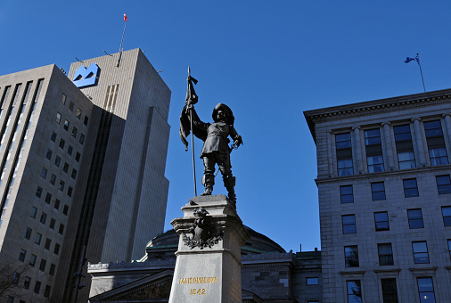 Montreal, QC, Canada, Nov. 8, 2023: A monument to the founder of Montreal, Paul de Chomedey, Sieur de Maisonneuve, stands at the heart of the landmark Place d'Armes square in Old Montreal.