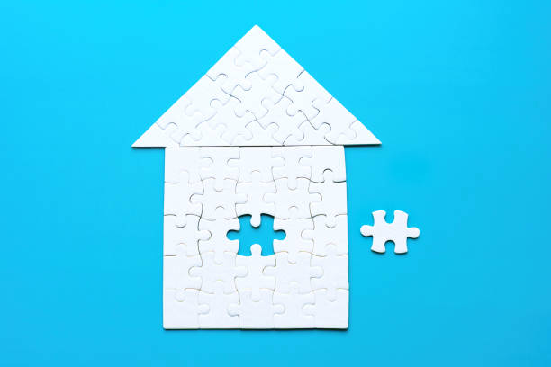 istock House-Shaped Puzzle with Final Piece to Be Set in Place 2048072932
