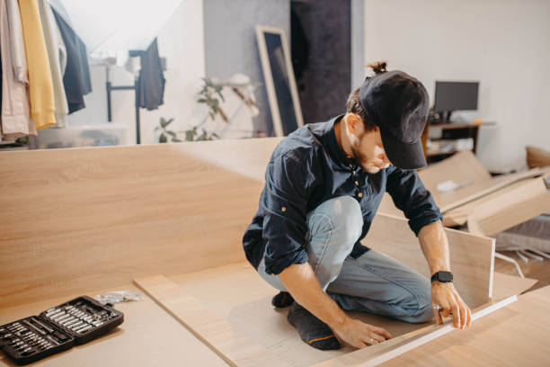 istock man at home using a screwdriver to assemble a new cabinet, assembling furniture 2048096395