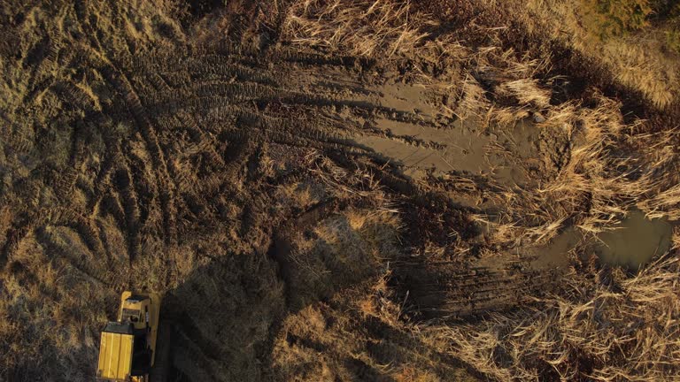 Overhead View ofHeavy Duty Earth Moving Equipment Loader Building Livestock Pond in Midwest USA Missouri Aerial Video