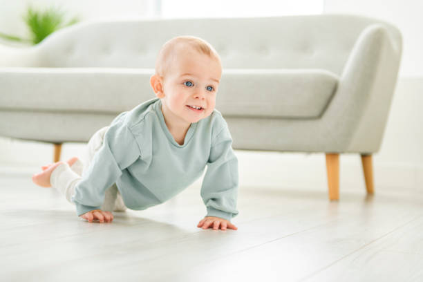 istock Happy toddler boy crawling in sitting room 2048110854
