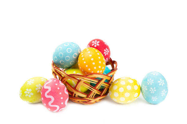 istock Easter basket filled with colorful eggs and a bouquet of tulips on  table. Easter celebration concept. Colorful easter handmade decorated Easter eggs. Place for text. Copy space 2048122112