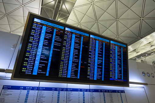 Hong Kong - February 19, 2024 : Flight information board at the Hong Kong International Airport.