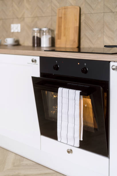 istock Selective focus on electric oven with opened door and turning on light in kitchen 2048138067